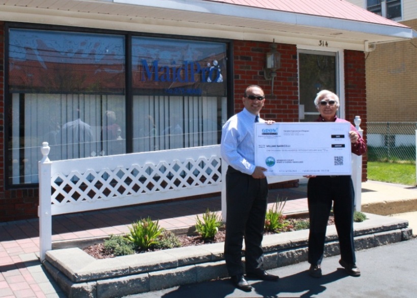 Freeholder Thomas A. Arnone presents a Façade Improvement Program reimbursement check for $1,758 to William Barricelli for improvements to his office building on May 5, 2014 in Keansburg, NJ.